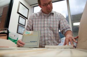 Archivist and Collections Manager Zach Jones is looking through KSTK's reels. Photo courtesy of Sealaska Heritage Institute.