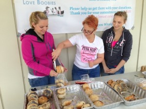 Beth Heller, Beth Comstock and Tyla Nelson make up a bag of bagels for a customer.