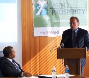Haa Aani CEO Russell Dick, left, listens as The Nature Conservancy Southeast Director Norman Cohen announces the Path to Prosperity competition in July.