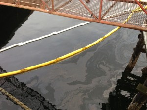 Sheen and containment boom above the sunken Silver Bay II - Photo by Shady Grove Oliver/KSTK
