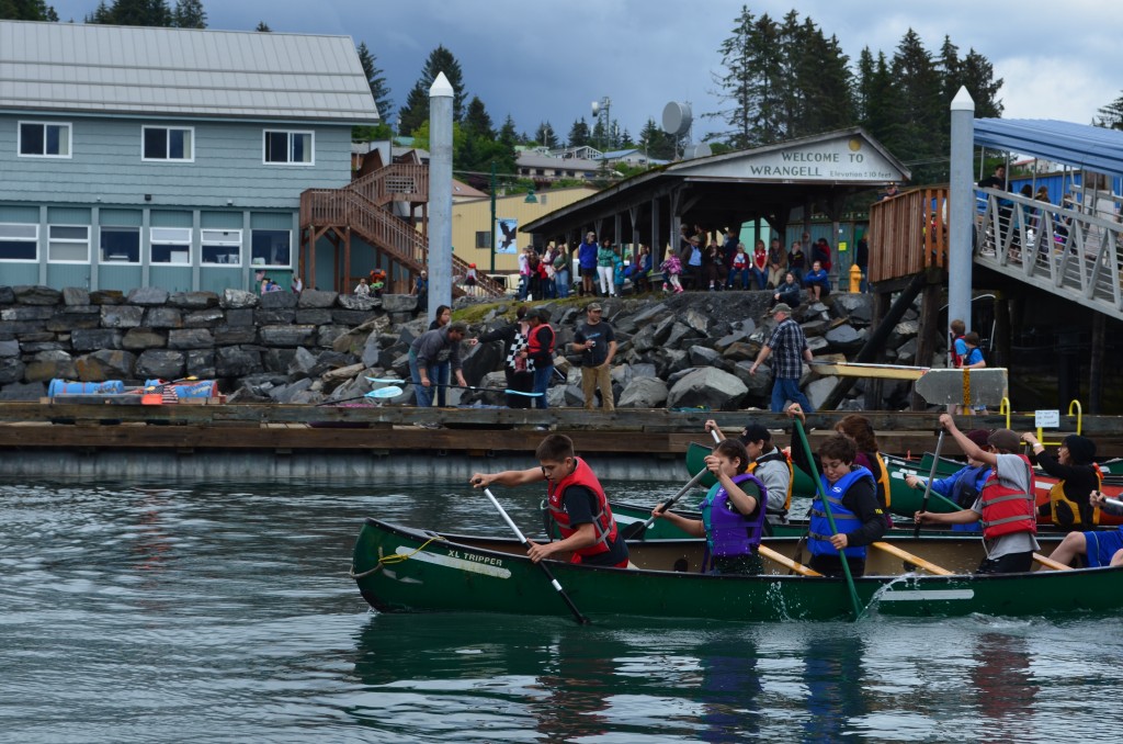 Paddlers fit as many people as they could into a canoe to compete in the "War Canoe" race Wednesday, July 2, 2014.