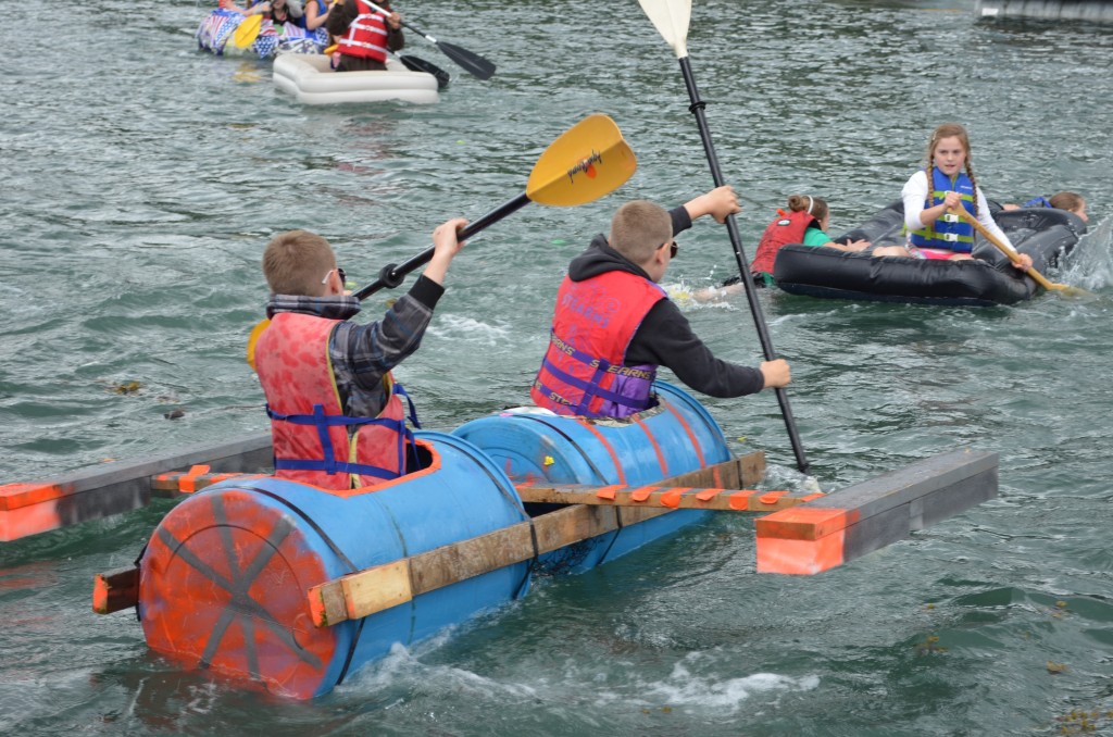 A Top Gun-themed boat competes in the Crazy Craft Race along with some air mattresses Wednesday, July 2, 2014.