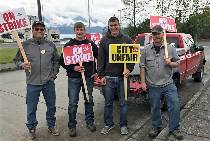 International Brotherhood of Electrical Workers representative Julius Matthew walks the picket line with Wrangell municipal workers Lorne Cook, Dwight Yancey and Andrew Scambler. (Photo courtesy IBEW)