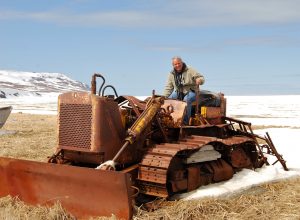 Mike Coffey poses on an old bulldozer in the Bethel area in 2009. He's retiring at the end of August from his job as Department of Transportation Southcoast Region director. (Photo courtesy Department of Transportation)