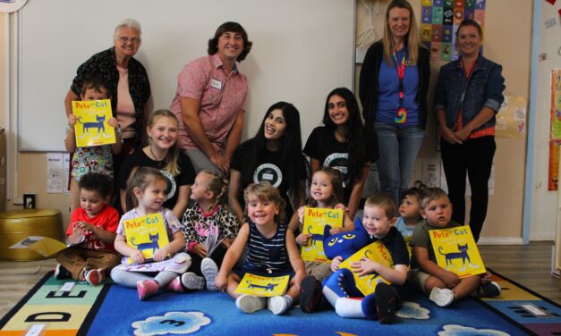 Volunteers foster literacy by reading to children and giving them books